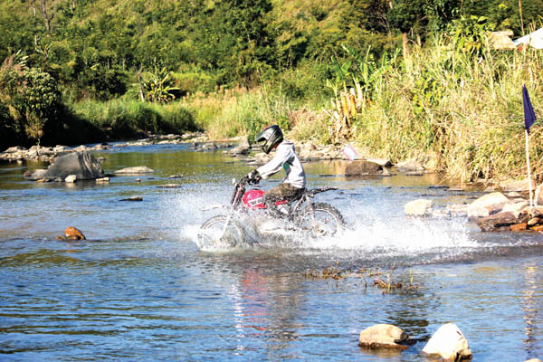 A biker crossing the Milak River in the motocross category during the same event at Khar village on Wednesday.