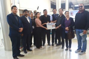 Managing partner of the Eastern Mirror, Khrietsonuo Rio and the director of Dimapur Airport Mughavi Zhimo, center, pose with a copy of the Eastern Mirror at the Dimapur airport on December 28. Eastern Mirror installed its fourth newspaper stand at the Dimapur Airport as part of the newspaper’s Corporate Social Responsibility. 