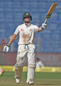 Australian batsman Steve Smith celebrates his half century during the 2nd day of the first test match against India in Pune on Friday. PTI 