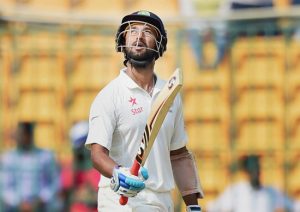  India's Cheteshwar Pujara raises his bat after his half century during the third day of the second test against Australia at the Chinnaswamy Stadium in Bengaluru on Monday.