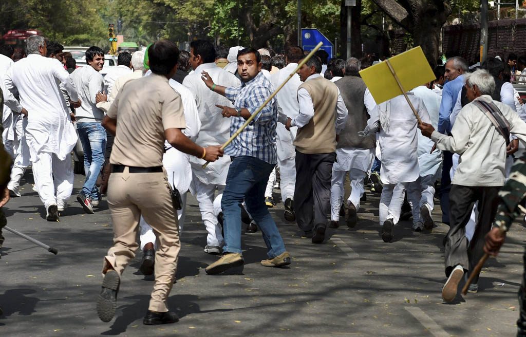 Policeman charges  INLD members during their protest march 'Gherao the Parliament' as they sought the intervention of PM Narendra Modi on the SYL canal issue. PTI Photo by Vijay Verma (PTI3_15_2017_000217B)