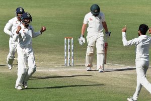 India's R Jadeja and C Pujara  celebrate the wicket of Australia's Steve O'Keefe during the 3rd day of last test match at HPCA Stadium in Dharamsala on Monday. 