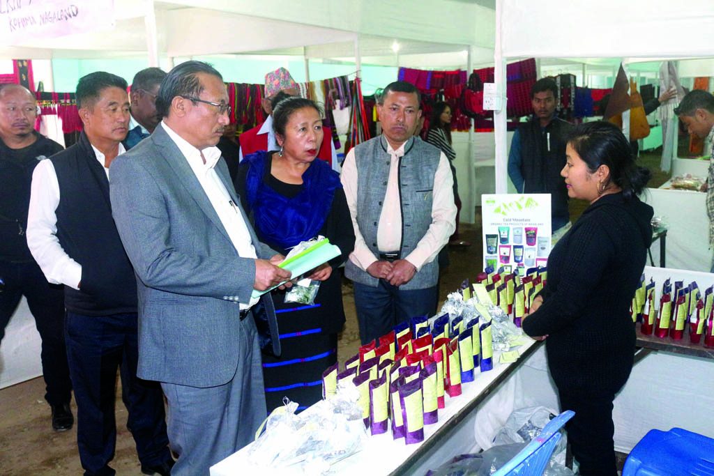 N Hushili Sema and her colleagues examine products at a stall at the National Handloom Expo in Kohima town on Wednesday. 