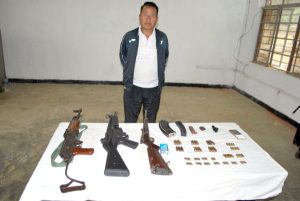 Accused person with the seized arms and ammunitions in police custory.