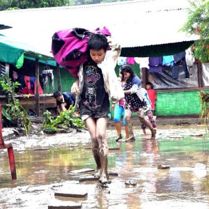 Children of flood hit orphanage at Karong in Manipurs Senapati district on way to take shelter at a safer place at Karong65 km north of Imphal on Saturday.