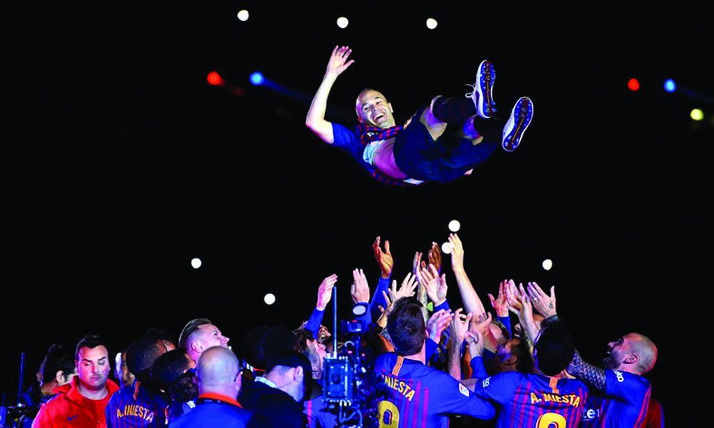 Andrés Iniesta is thrown in the air by team mates after positively his final game for Barcelona.