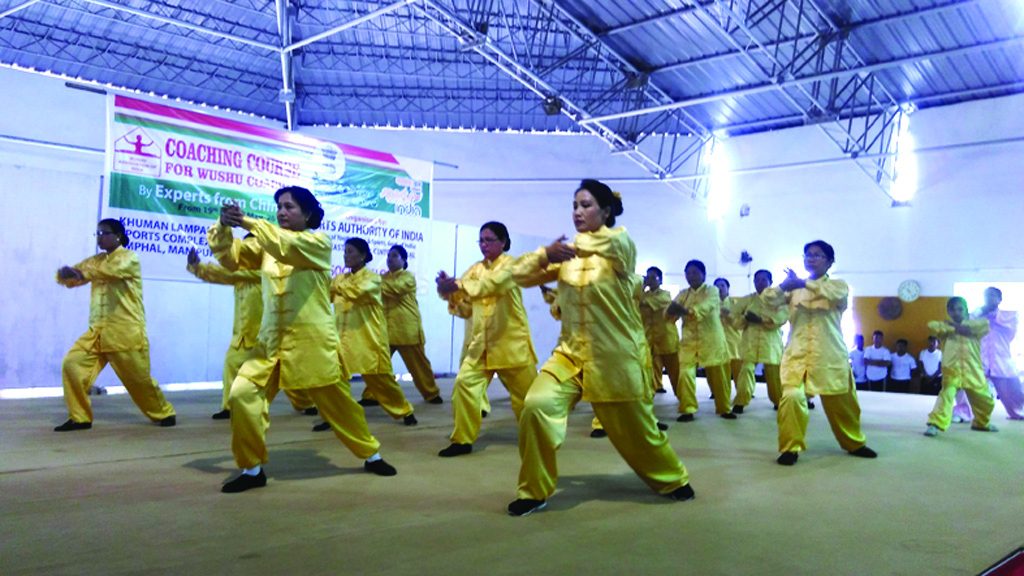 womenfolks in wushu attires displaying a wushu demonstration during the inaugural funcrion of 5 day first ever National seminar coaching courses for wushu coaches in Imphal on Monday