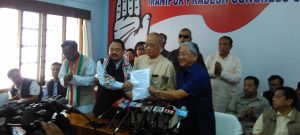 CLP leader O Ibobi and MPCC president Gaikhangam handing over official letter of party to outer Manipur candidate K James in Imphal on sunday pic Sobhapati Samom